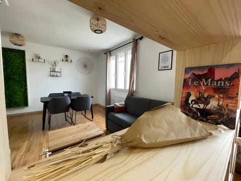 Elegant living room with sofa bed, wall decorations and dining table.