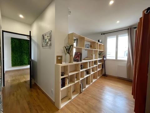 Modern shelf elegantly separates the living room, adding a touch of sophistication.