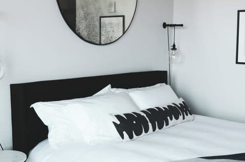 Drift off under fluffy pillows and calming, modern décor.