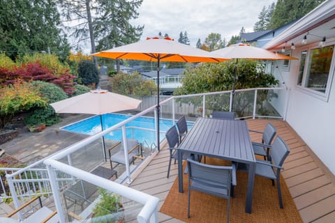 View to large heated pool from patio deck outdoor dining area