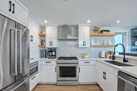 KITCHEN – Enjoy cooking in a fully equipped kitchen with stainless steel appliances, sleek countertops, and everything you need to prepare your favorite meals.