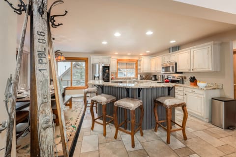 Fully Equipped Open Kitchen with Stainless Steel Appliances, and Bar Seating for 5