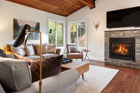 Snuggle in the spacious living room with gas fireplace and open to the dining area and kitchen.