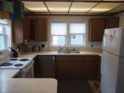KITCHEN:  The home includes a full kitchen with all appliances including a dishwasher.  A good supply of cooking and dining utensils are included as well.