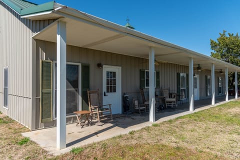 Covered porch with rocking chairs.