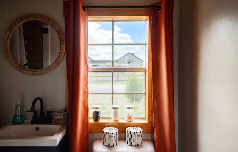 Rustic charm meets simple comforts- with a view you didn`t expect from the bathroom.
