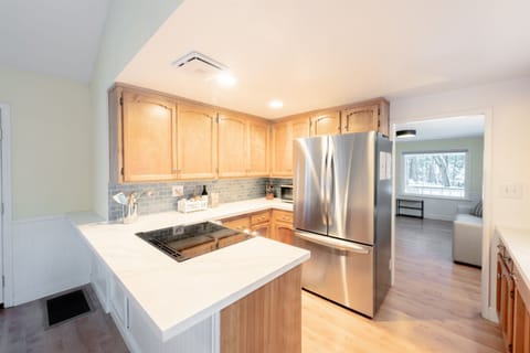 The open-concept kitchen is highlighted by a central island with a cooktop, providing a spacious area for meal prep.