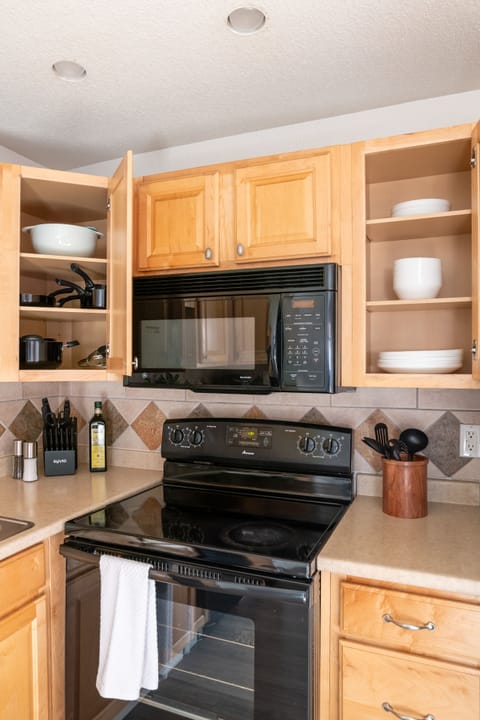 Cookware and dinnerware is strategically tucked hidden in the cupboards