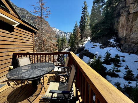 Cozy deck nestled beneath a majestic mountain, offering stunning views of the surrounding beauty