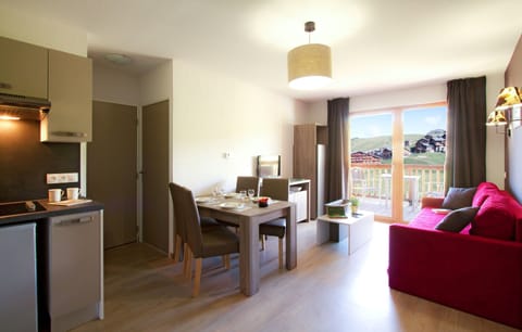 The living area is decorated in warm and lively colours. Views vary.