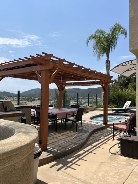 Again, dining table with 8 people seating under the patio shade with a view