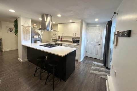 Full kitchen with gas range, refrigerator, dishwasher, microwave, and toaster.