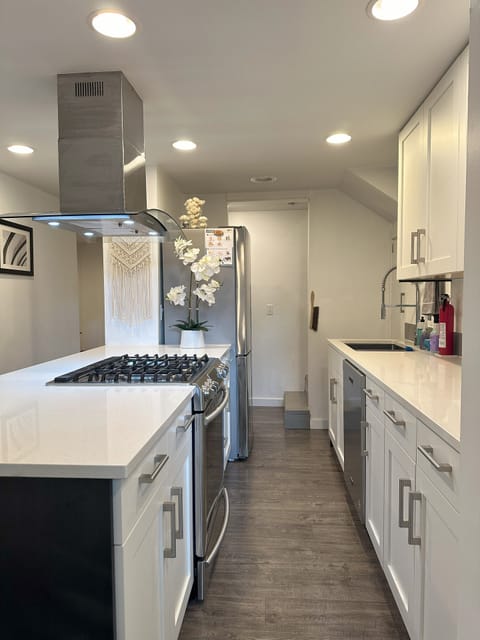 Full kitchen with gas range, refrigerator, dishwasher, microwave, and toaster.