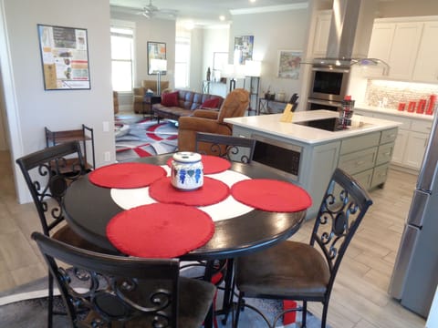 Looking from eating area through TV area with main entrance area in background.