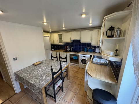 Kitchen with dishwasher, washing machine, Microwave combination oven, gas range.