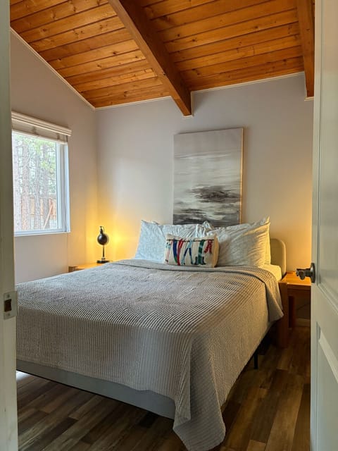 Wake up looking at the trees in this cozy queen bed