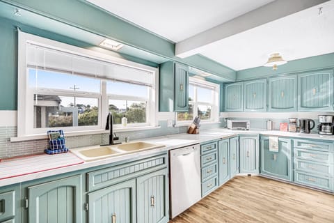 Large kitchen with coffee maker, grinder, microwave, crockpot, blender and serve ware. (2)