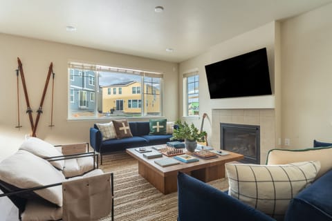 Living room with TV, windows, and board games
