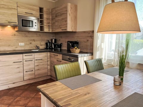 Furniture, Flooring, Interior Design, Wood, Cabinetry, Kitchen, Countertop, Floor, Chair, Kitchen Appliance