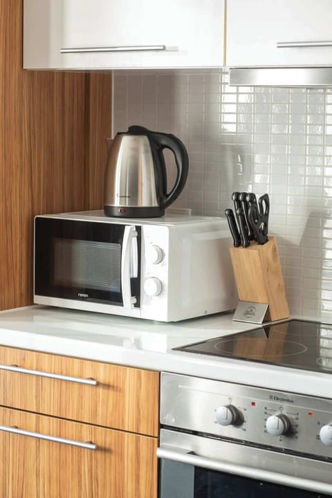 Microwave oven and electric kettle. The appliances in the kitchen provide the necessary space to prepare home-cooked meals.