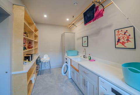 utility room with washing machine and tumble dryer