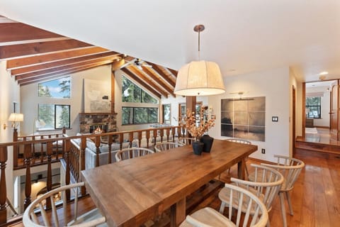 Stunning designer dining area with rustic wood accents, vaulted ceilings, and forest views!