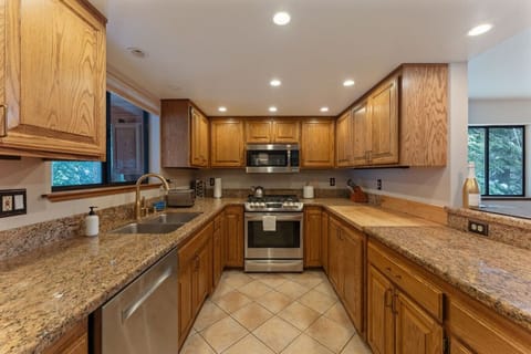 Fully equipped kitchen with granite counters, modern appliances, and rustic charm!