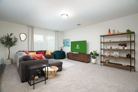 Relax in style in this spacious and cozy living room! Featuring a large TV with Xbox for entertainment, plush seating, and modern décor—perfect for movie nights or unwinding after a long day.