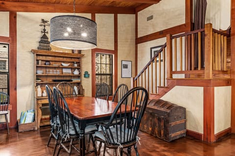 A charming wooden dining table with seating for six exudes rustic elegance.