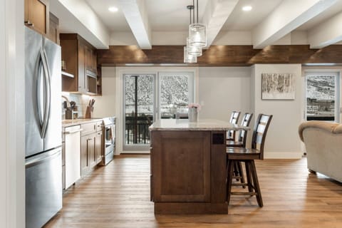 The fully-equipped kitchen boasts an island with seating for 4, allowing for easy socializing **BALCONY NOT AVAILABLE**