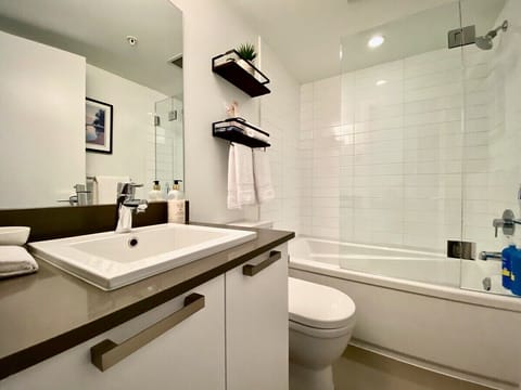 3-piece bathroom with tub/shower combo. Glass shower door hinges open for easy access.
Forgot your toothbrush? Please help yourself to a complimentary toothbrush & toothpaste. 
Also included; organic shampoo, conditioner, bodywash & handsoap