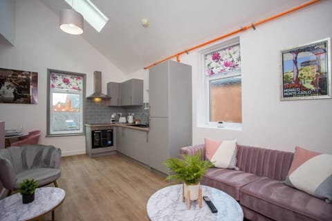 The spacious living area invites you to relax and unwind, with a comfortable couch beckoning you to sink into its plush cushions.