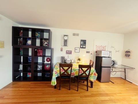 Dining area with dining table, chairs, napkins, plates, forks, cups, tea, coffee