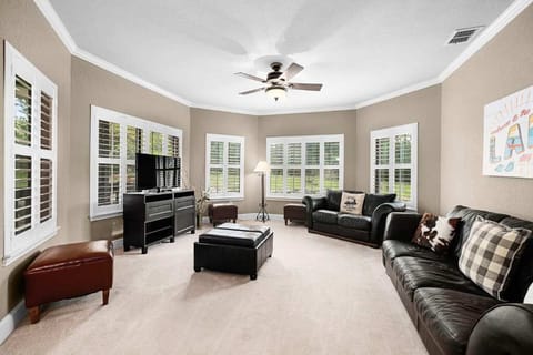 Unwind in the living room with a cozy TV setup for your enjoyment.
