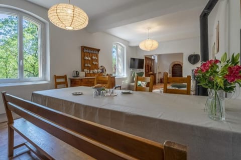 A large dining table, adjacent to the kitchen, perfect for family meals