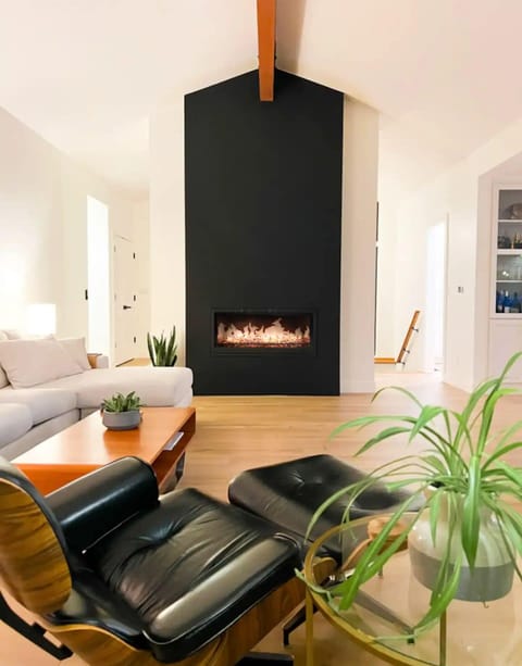 Large living room with TV, fireplace and lots of natural light. 