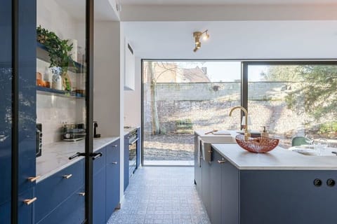 Elegant kitchen corner with sleek blue cabinetry.