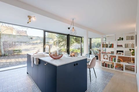 Bright open kitchen with large windows and garden view.