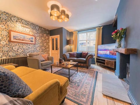 Snug lounge with wood burner, smart TV and access to Main Street