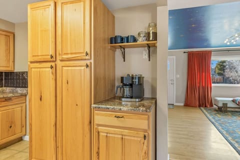 Fuel your mornings with ease at the coffee station in the kitchen, complete with a Keurig coffee maker, an array of mugs, and a selection of coffee capsules.