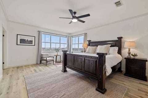 Primary bedroom with Large King bed and seating area.