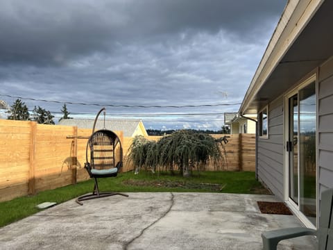 Relax on the patio in the enclosed back-yard.
