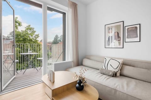 Cozy living room with private balcony access and sleeping sofa