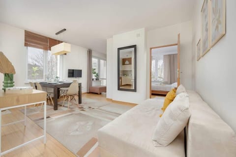 A spacious and elegantly designed living room with a comfortable sofa, a wooden coffee table, and stylish decor, creating a cozy atmosphere.

