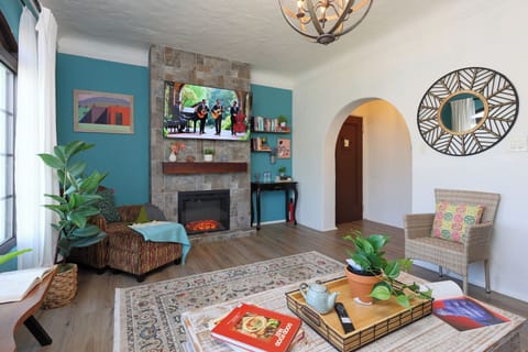 Spacious living room with smart TV, and lots of natural light.