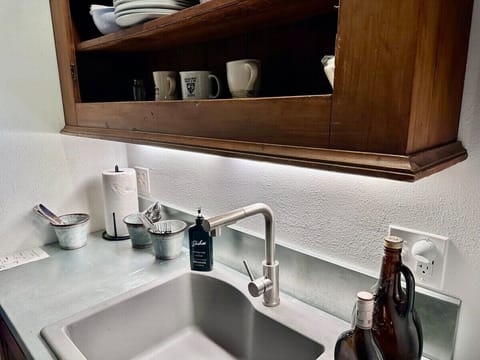 Effortless elegance meets practicality at the kitchen sink, adorned with sleek fixtures and surrounded by modern conveniences.