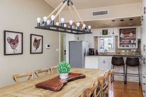 Enjoy memorable dining experiences in the welcoming ambiance of the dining area, featuring a beautiful wood table, stylish chairs, and plenty of natural light.