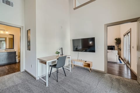 Primary Bedroom with TV, office desk, and chair