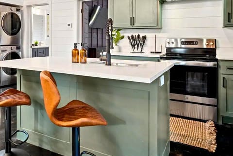 Modern kitchen features a convenient breakfast bar with stylish stools