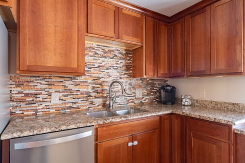 Coffee maker with an array of coffee capsules at the kitchen countertop